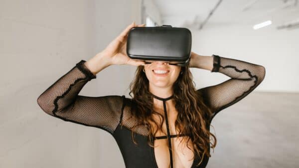 Smiling Woman in Black Top Wearing Virtual Reality Goggles